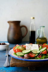 Traditional Greek salad. Light and healthy food. Blue  food background
