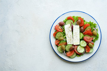 Traditional Greek salad. Light and healthy food. White food background