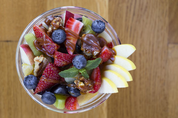 Bowl with fruit salad and caramel topping