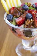 Bowl with fruit salad and caramel topping