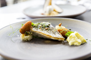 Plate with tasty fish steak on grey background