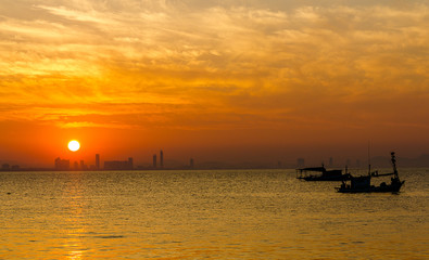 Fototapeta na wymiar Sunset in the sea on silhouette background