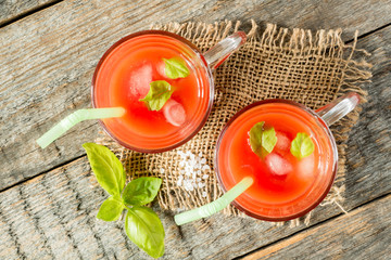Red cocktail with tomato juice, Basil and salt, selective focus