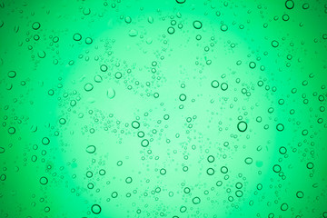 Rain droplets on green glass background, Water drops on glass.