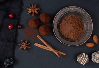 Classic truffles in cocoa powder, cinnamon sticks, baden and other ingredients