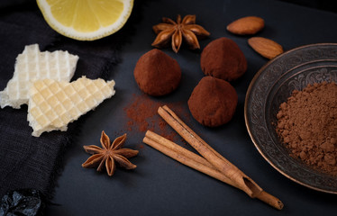 Classic truffles in cocoa powder, cinnamon sticks, baden and other ingredients