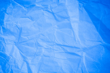 Crumpled blue paper background.