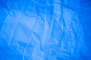 Crumpled blue paper background.