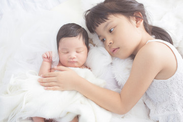 Fototapeta na wymiar cute big sister with new newborn baby