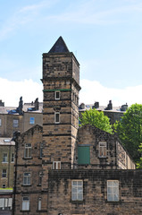 old stone mill with tower in front of hillside streets of tall stone houses set in the woodland landscape in hebden bridge west yorkshire © Philip J Openshaw 
