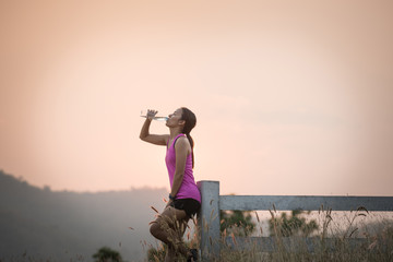 woman jogger drinking water - Fitness, people and healthy lifestyle