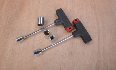 various professional metalwork tools on a background of beech wood