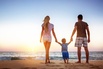 Happy family beach holidays vacations sunset concept