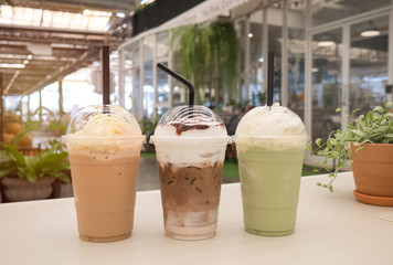Chocolate,green tea frappe and coffee frappuccino on white table