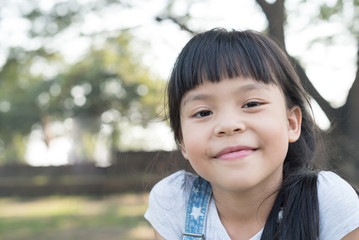 Happy little girl having fun at the park