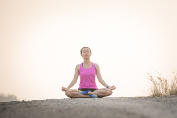 Fototapeta na wymiar woman practices yoga and meditates in the lotus position