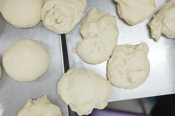 pieces of dough lying on a steel table top