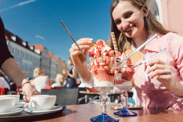 Woman enjoying her ice cream with strawberries