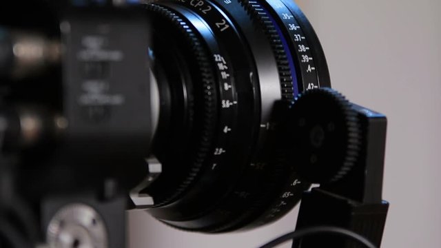 Professional camcorder turns from side to front with working gear of radio-focus close-up (1080p, 25fps)