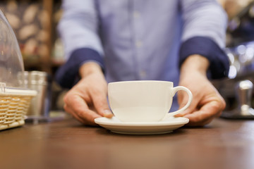Photo of barist man with cup of coffee