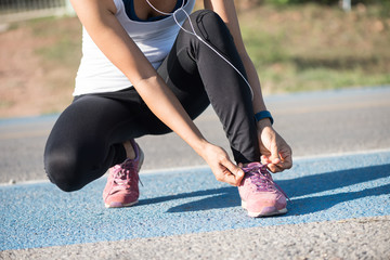 Young woman running outdoors at sunrise or sunset. Wellness and health concept.