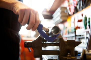 Photo of master mending pipe in workshop