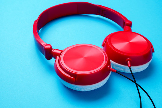 Photo of red with white headphones for music from above