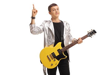 Teenage rocker with an electric guitar holding his index finger up