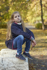 Girl in autumn yellow leaves