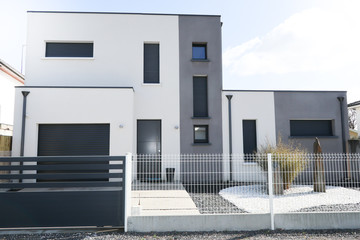 white gray house exterior with entrance door and garage