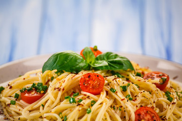 Pasta with vegetables on wooden table