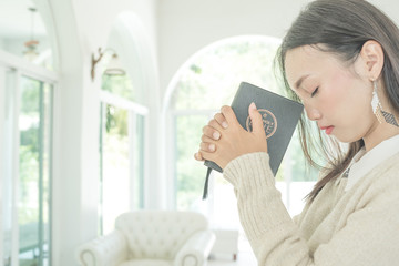 woman hands praying to god with the bible.