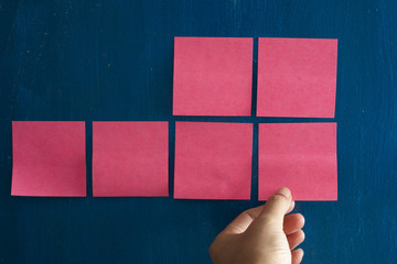 Hand pick Post it paper on brainstrom board