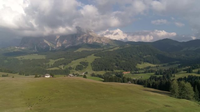 Aerial Drone video of the Sassolungo mountains on the Italian Alps Dolomites with birds flying on the foreground