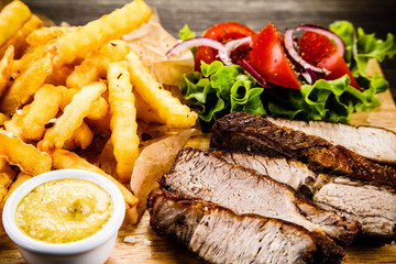 Grilled beefsteak with french fries and vegetables