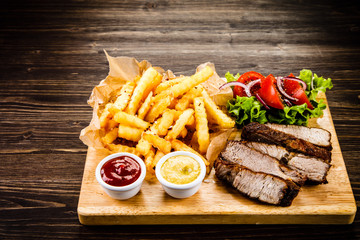 Grilled beefsteak with french fries and vegetables