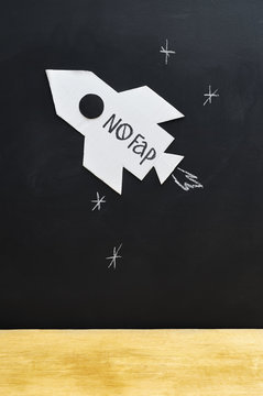 A cardboard rocket with the inscription "No Fap"