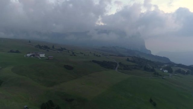 Aerial Drone video of the Schlern Massiccio dello Sciliar mountains on the Italian Alps Dolomites with birds flying on the foreground