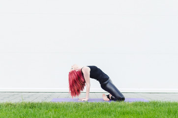 Fototapeta premium Woman stretching outdoors in a park
