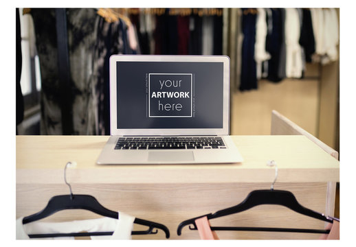 Laptop on Table in Clothing Store Mockup