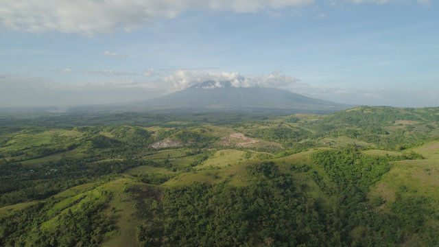 Aerial view of mountain valley with hillscovered forest, trees, mount Iriga. Luzon, Philippines. Slopes of mountains with evergreen vegetation. Mountainous tropical landscape.