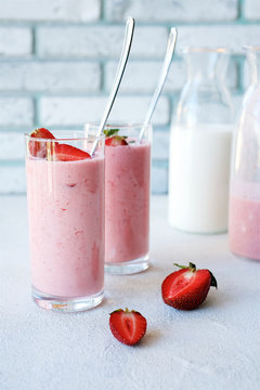 Strawberry smoothies with yogurt or milk. Spring or summer cocktail in glass on white background
