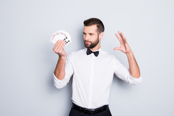 Portrait of cunning foxy magician with modern hairstyle and stubble in white shirt with bowtie...