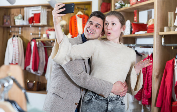 Couple is satisfied shopping and taking selfie