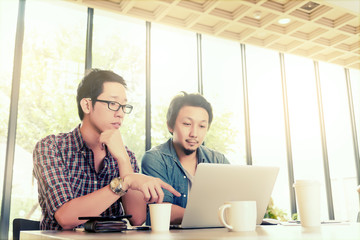 Asian Team group freelancers or students in casual suit are brainstorming and meeting at coffee shop cafe. Business and Office Concept.
