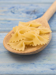 Italian pasta on a blue wooden background. 