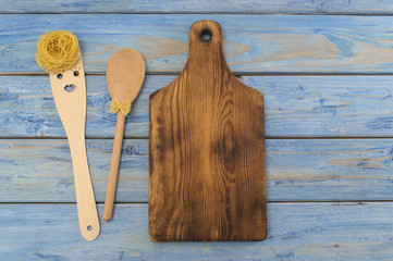 Italian pasta on a blue wooden background. 