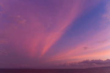 summer sunset colorful sky with dramatic  purple red and yellow clouds over picturesque water landscape. Bali, Indonesia.