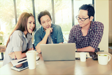 Asian Team group freelancers or students in casual suit are brainstorming and meeting at coffee shop cafe. Business and Office Concept.