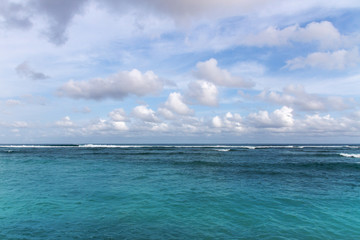 Colorful ocean seascape with azure water and blu sky with clouds